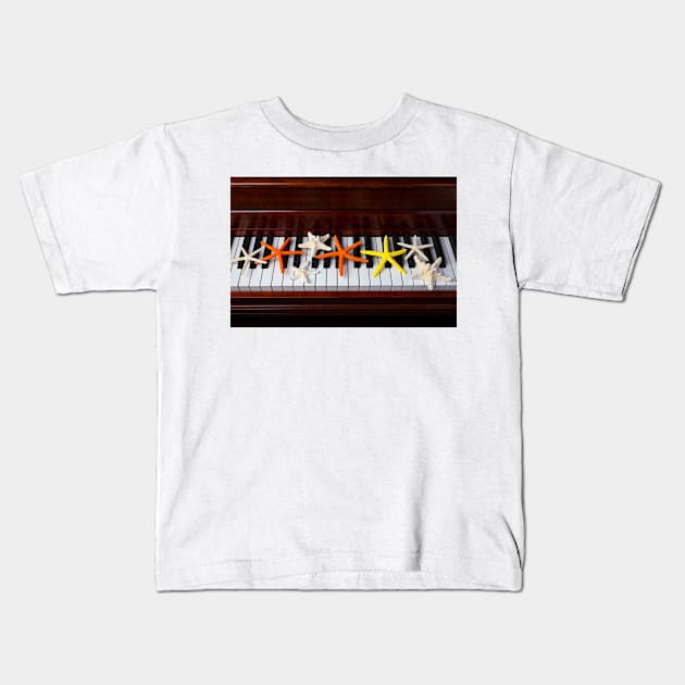 Starfish On Piano Keys Kids T-Shirt by photogarry